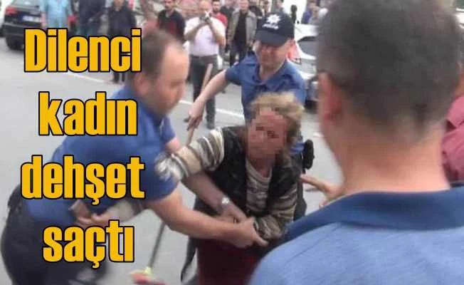 Dilenci kadın cemaate saldırdı, polisin silahını almak istedi